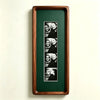 A vertical photo strip frame with a dark green background displaying multiple portrait photos.