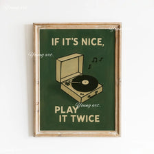 A framed canvas art print featuring green background text that reads If it's nice play it twice