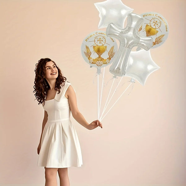 A woman holds a bunch of white foil balloons featuring religious symbols for a christening or baptism celebration.
