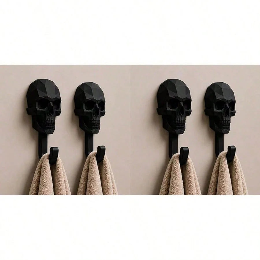 A row of black 3D skull wall hooks displaying gothic decor for hanging towels and coats.