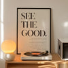 A framed inspirational quote canvas wall art poster with black text on a white background displayed on a wooden shelf.