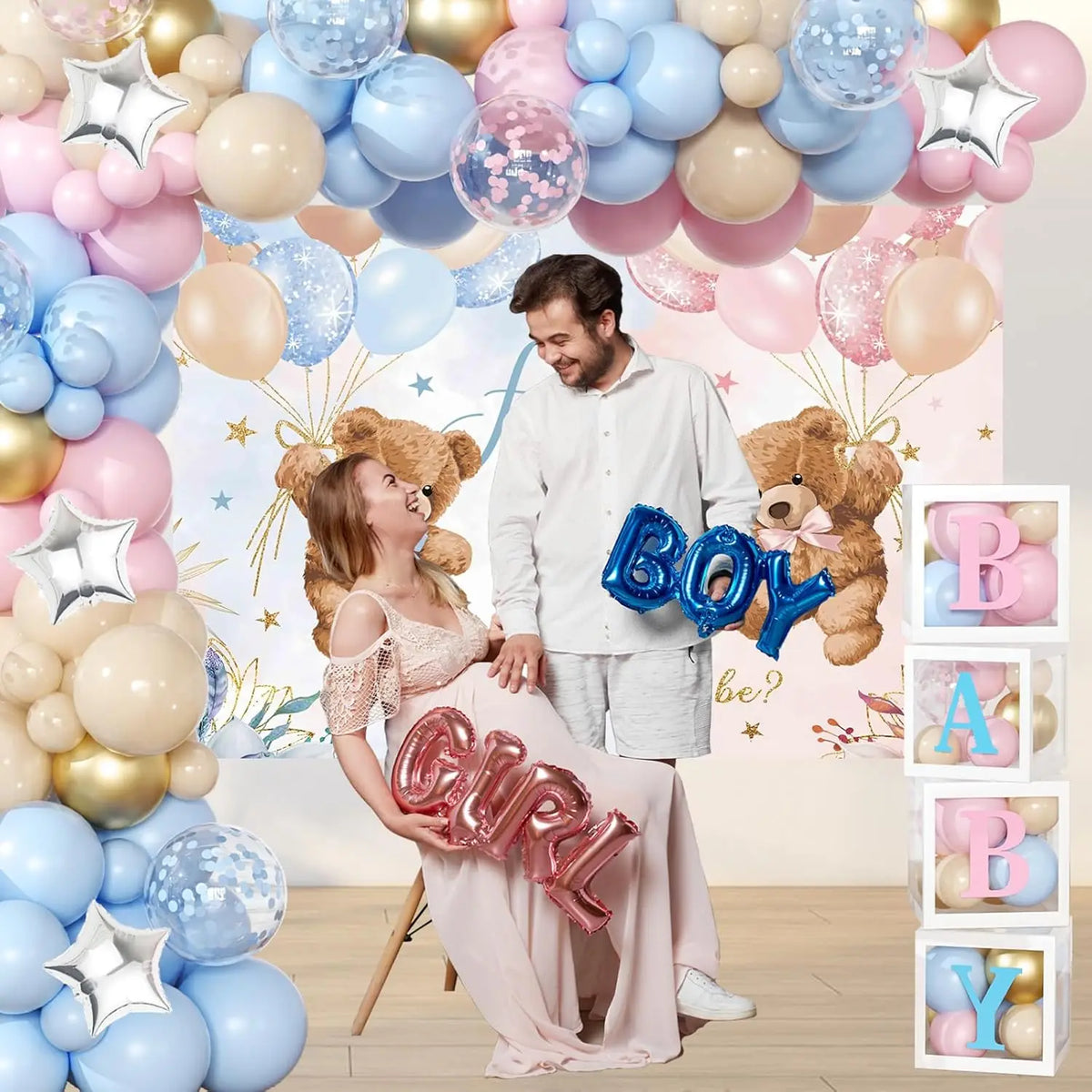 A woman in pink clothing stands next to a balloon arch featuring pink, blue, gold, and nude balloons with teddy bears.