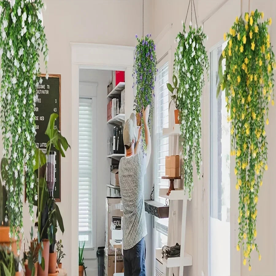 Three lifelike faux eucalyptus hanging plants in green and yellow cascade from the ceiling.