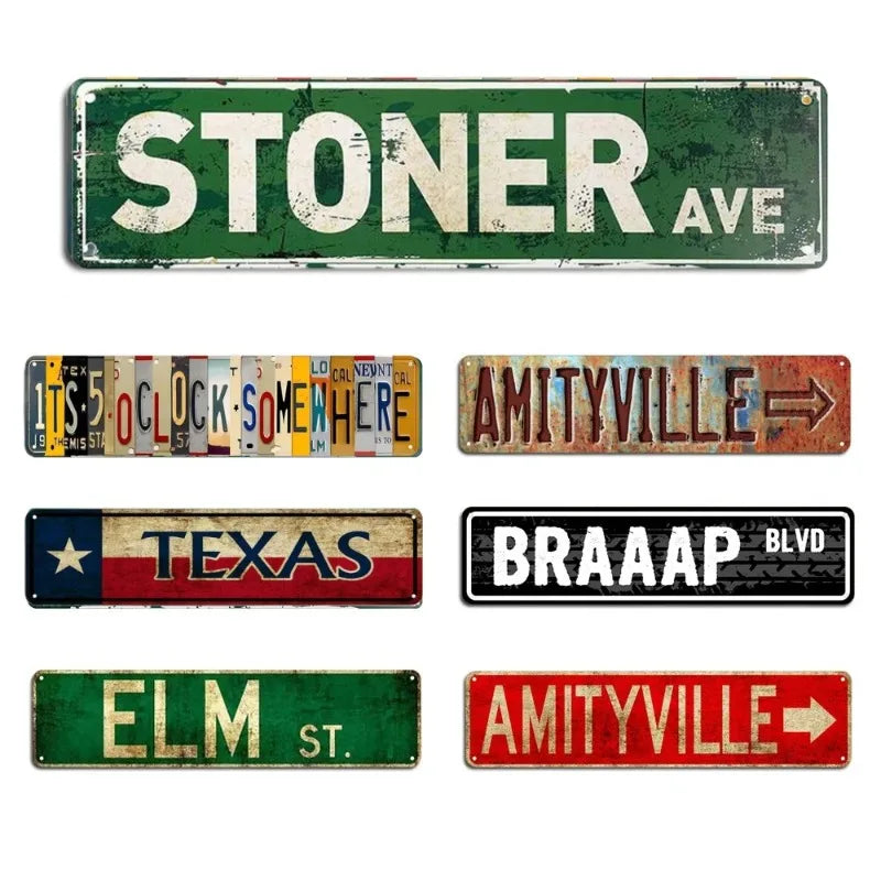 A collection of rustic metal signs featuring various text and designs including STONER AVE, AMITYVILLE, TEXAS, BRAAAP BLVD, E