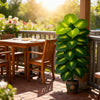 A vibrant green artificial palm tree with 24 leaves sits in a pot on a wooden deck railing.
