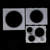A set of plastic sizing boxes with various circular holes for balloon decor.
