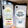 A clear phone case decorated with watercolor graphics featuring a sunrise, leaves, and inspirational phrases about faith and 