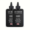 Two black dropper bottles of UV resin formulated for artists with labels indicating fast curing and no shrinking