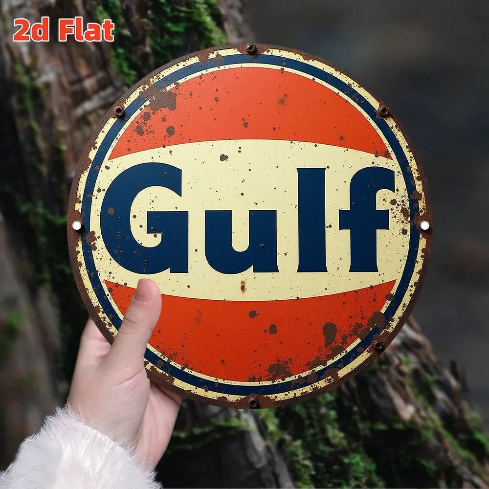 A vintage round metal sign with the word Gulf in blue text on a yellow background, attached to a tree trunk.