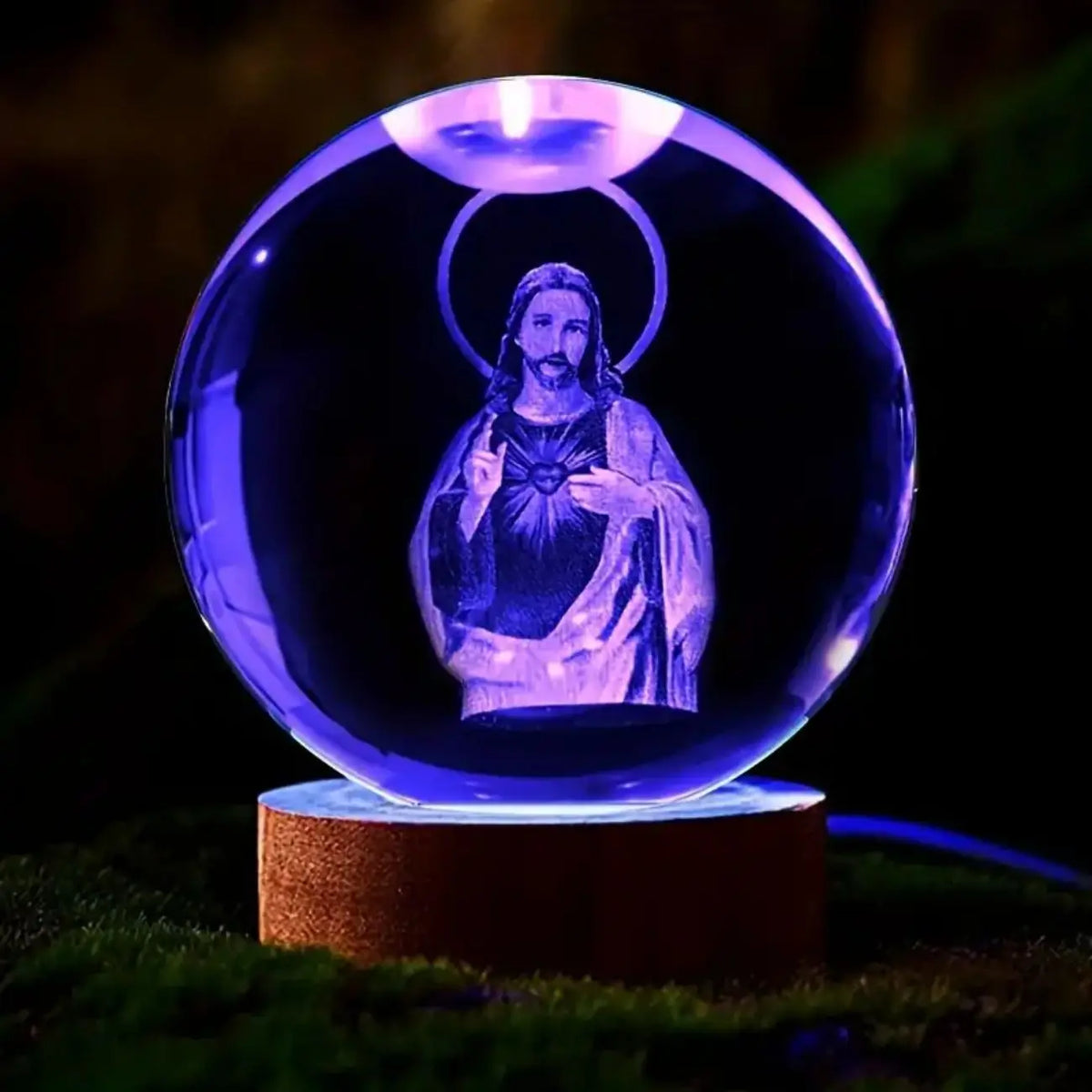 A glowing blue crystal ball night light featuring a silhouette of Jesus with a halo.