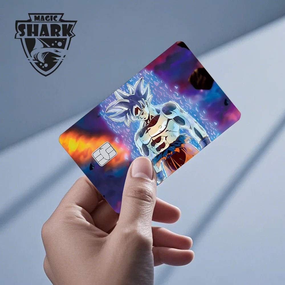 A hand holds a Dragon Ball Super Saiyan card skin sticker featuring Goku in a vibrant purple and blue background.