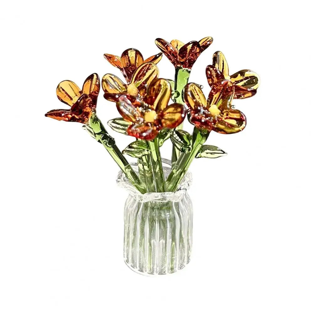 Hand-blown glass flower bouquet with orange and yellow blooms in a clear glass vase