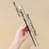 A hand holds a natural clear quartz zodiac crystal wand with a gold-colored handle and a clear crystal point.