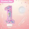 A pink glitter number one candle and a white circular lid for a birthday set.