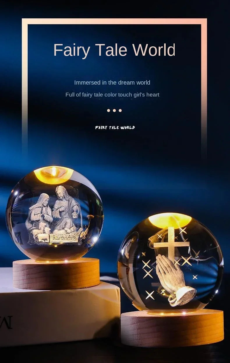 A glass crystal ball night light featuring a scene of two figures and a cross, set against a dark blue background.