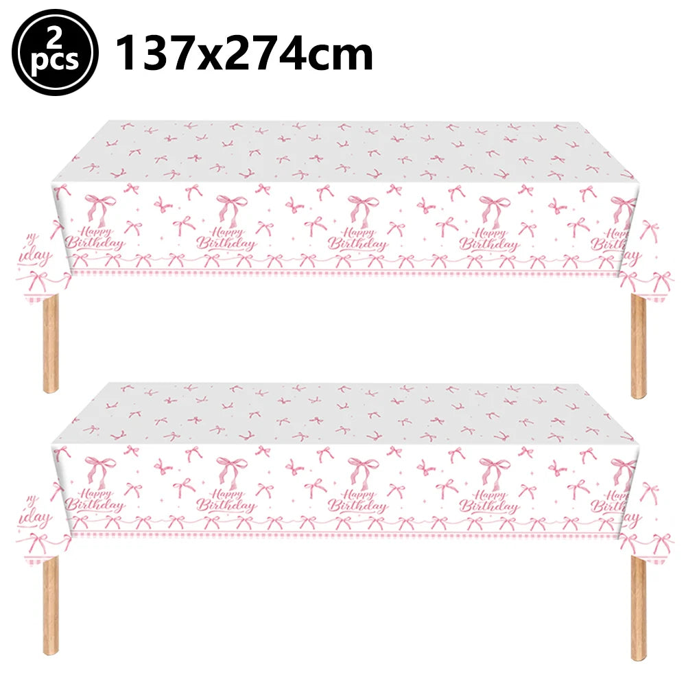 Pink bow themed birthday party supplies set featuring two rectangular table cloths