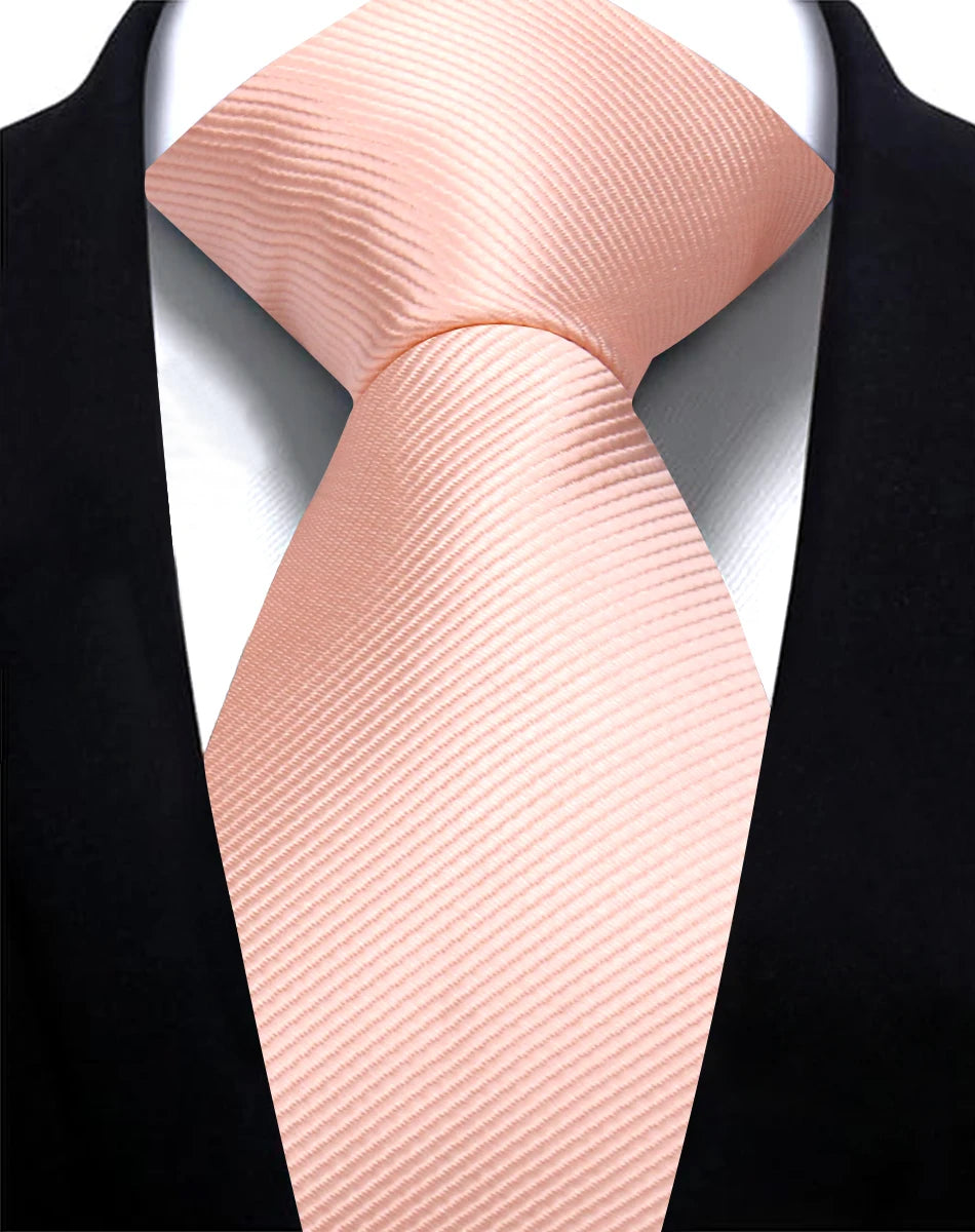A pink silk necktie tied in a knot against a black suit jacket.
