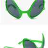 A pair of bright green, quirky sunglasses with dark gray lenses shown in a close-up view.
