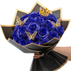 A bouquet of ten deep blue glitter artificial roses with gold butterfly accents displayed in a black decorative bowl.