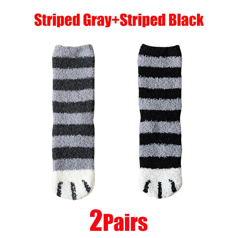 A pair of striped gray and black cat paw print plush socks.