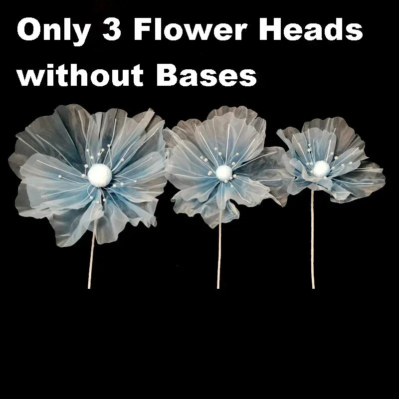 Three light blue velvet mesh flower heads without bases for wedding decoration.