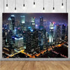 A photograph of a sprawling night city skyline featuring numerous illuminated high-rise buildings.