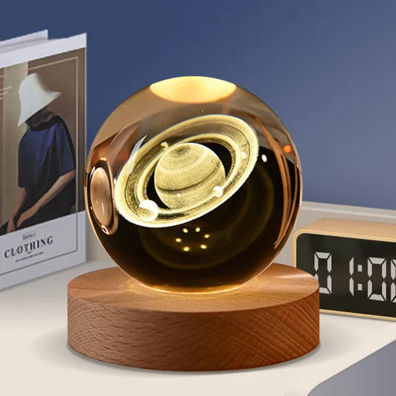 A dark amber crystal ball with a gold sphere inside rests on a wooden base.