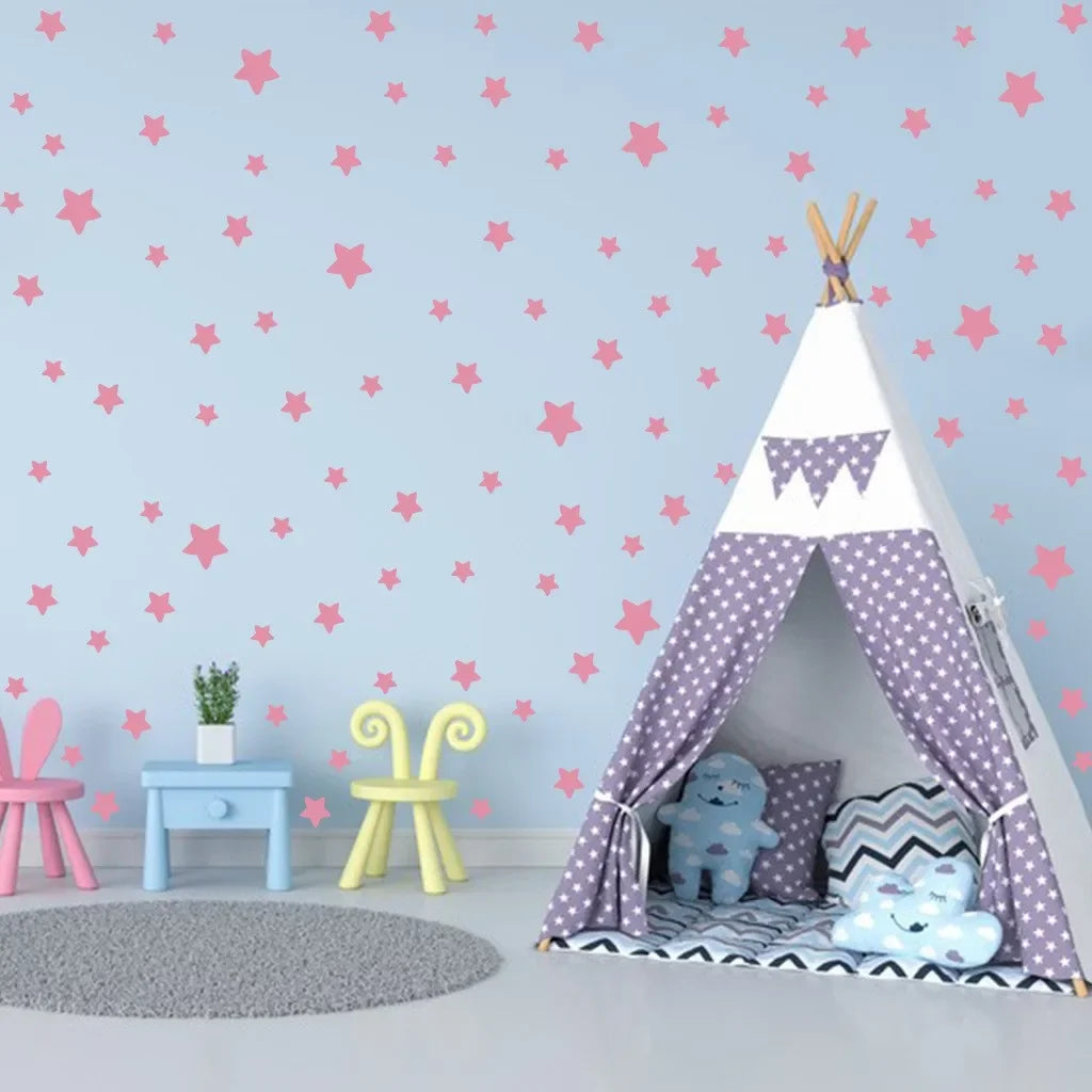 A white teepee tent decorated with purple polka dots and a purple blanket, set against a light blue wall with pink stars.