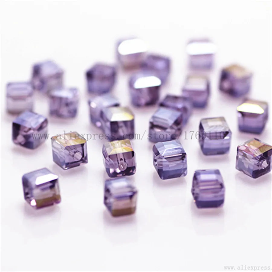 A collection of square cut glass crystal beads in various shades of purple and gray.