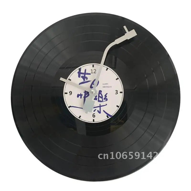 A black decorative vinyl record wall clock with a white face and Chinese characters.