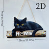 A black cat silhouette on a rustic wooden sign with the word HOME carved into it.