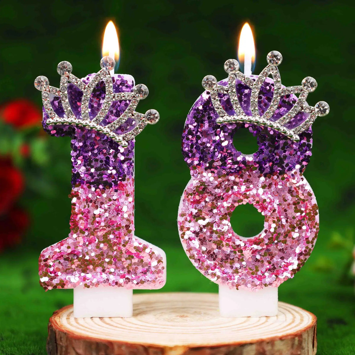 Glitter number 18 birthday candle with rhinestone crown cake topper on a wooden surface.