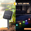 A black solar powered garden light with a panel is shown next to a plant, illustrating 8 hours full charge.