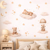 Wall stickers featuring cartoon bears, stars, and clouds decorating a bedroom wall.
