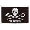 Black tapestry featuring a white skull and crossbones with a pirate sword design and the text SEA SHEPHERD