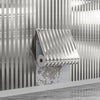 A roll of metallic gold striped peel-and-stick wallpaper is mounted on a textured wall surface.