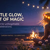 A woman wearing a glowing LED flower crown sits outdoors at night with a campfire and palm trees.