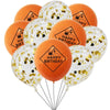 A bunch of orange and white latex balloons decorated with gold confetti and happy birthday text.