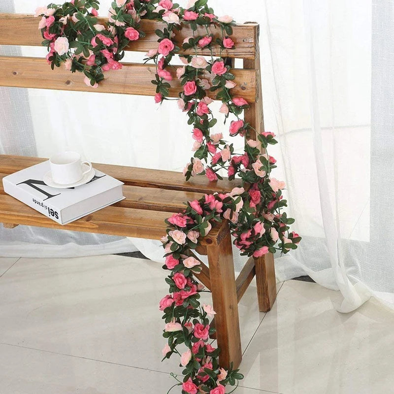 A wooden bench decorated with a pink silk rose garland for wedding and home décor.