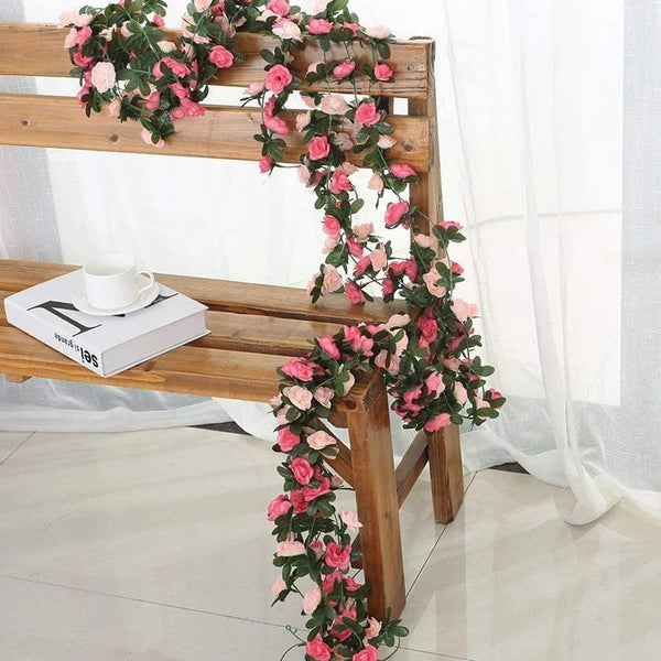 A wooden bench decorated with a pink silk rose garland for wedding and home décor.