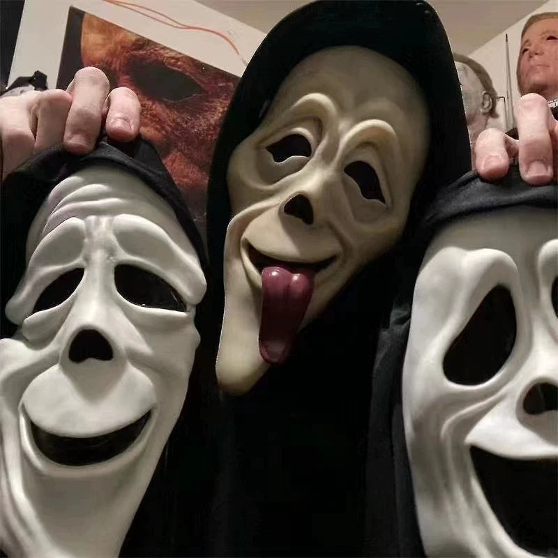 A close-up of several white skeleton horror masks being held up by hands against a dark background.