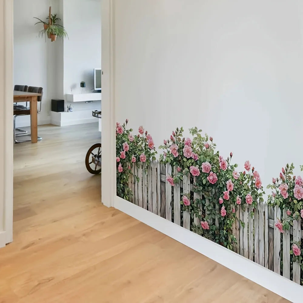 A white wooden fence wall decal featuring pink and green floral vines on a light wood background.