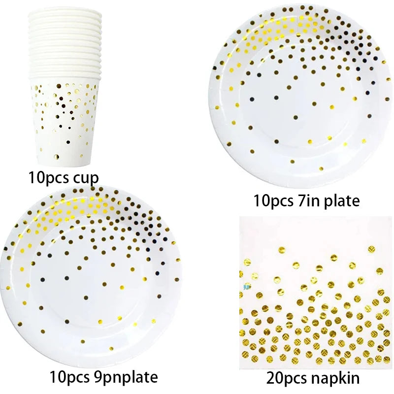 A set of gold polka dot disposable party tableware including cups, plates, and napkins.