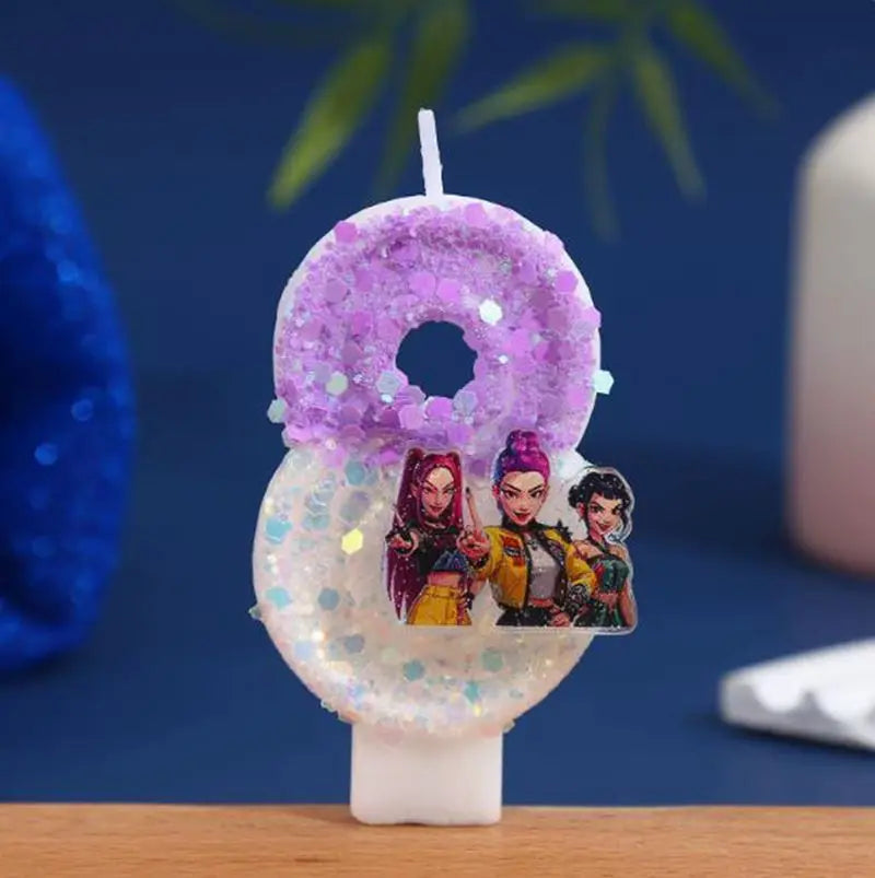 A set of purple and iridescent glitter birthday candles shaped like numbers 0 through 9