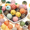 A collection of natural wooden checkered beads in various colors including pink, yellow, green, and brown.