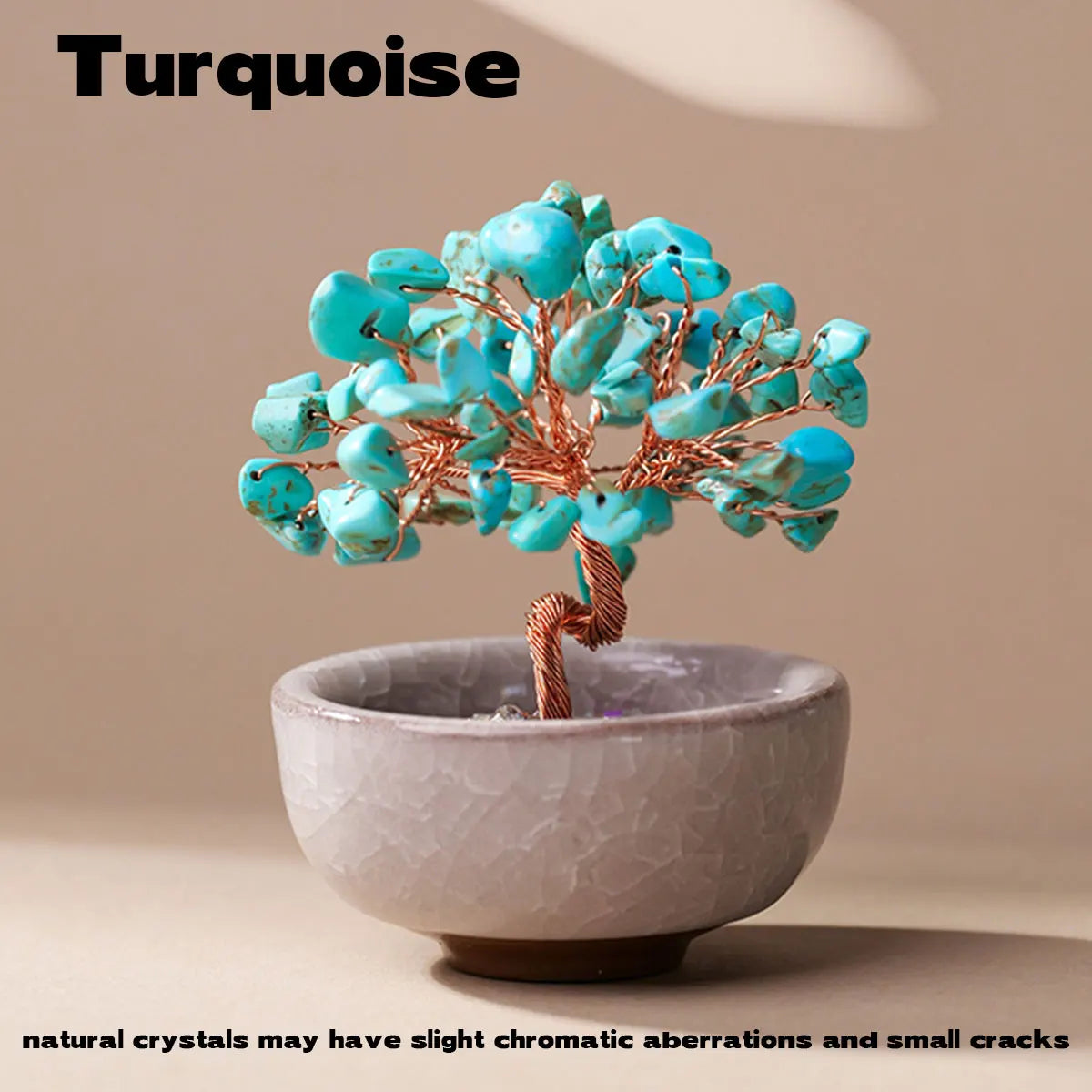 Turquoise crystal tree with blue stones mounted on a copper wire base in a light gray bowl.