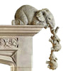 A detailed resin figurine set of an elephant hugging a baby, displayed on a stone pedestal.