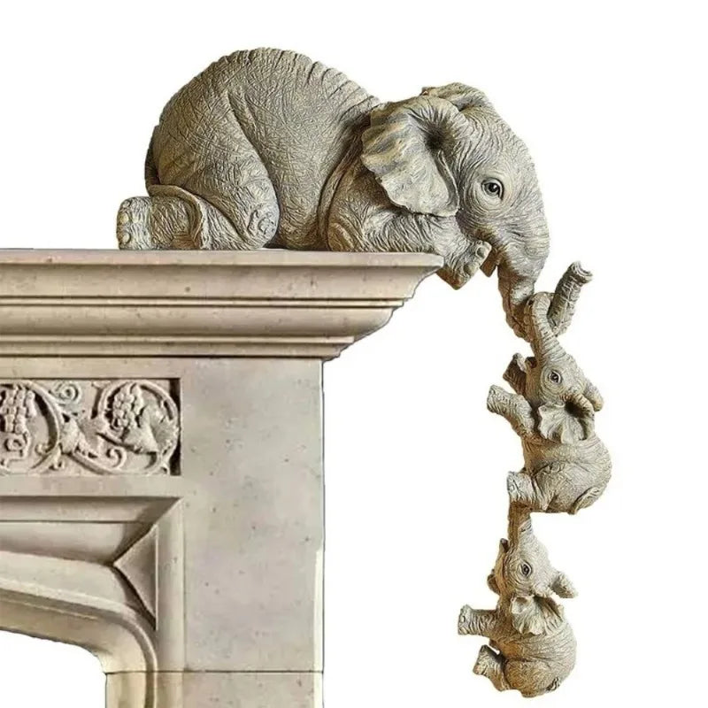 A detailed resin figurine set of an elephant hugging a baby, displayed on a stone pedestal.