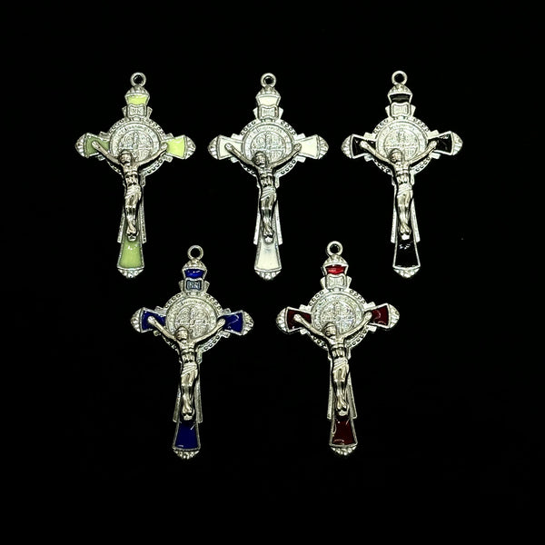 A collection of six silver crucifix pendants featuring enamel finishes and various designs.