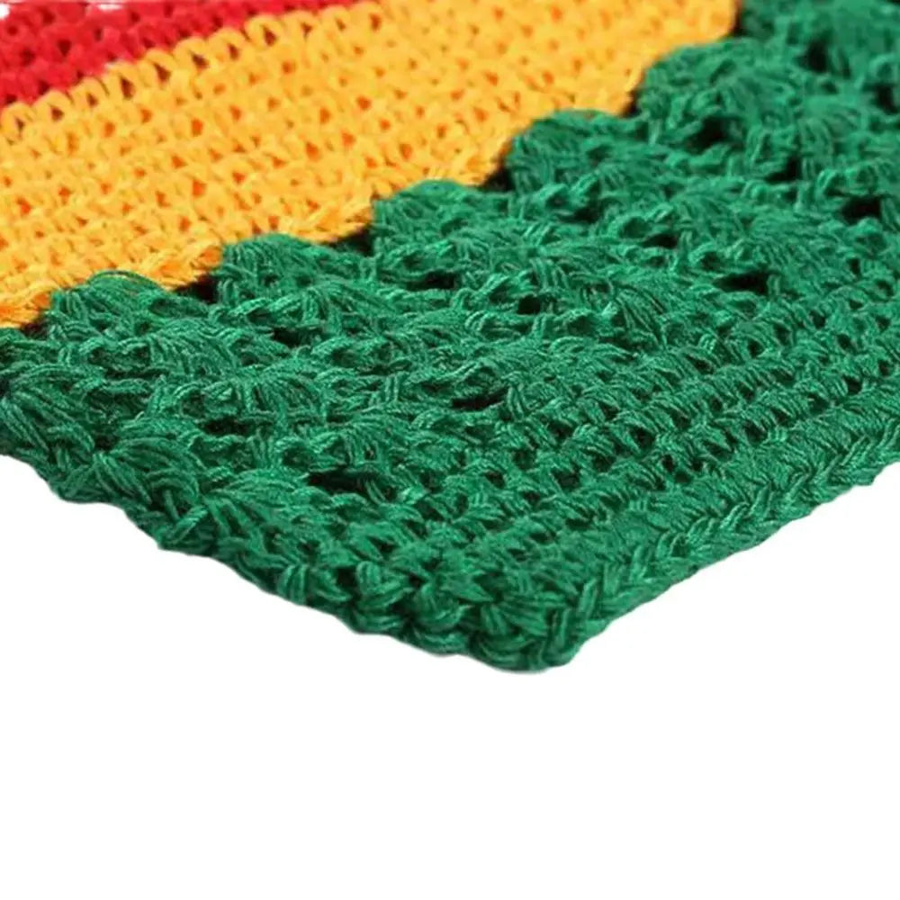 Close-up of a handmade crochet beanie hat featuring a gradient color transition from orange to green.